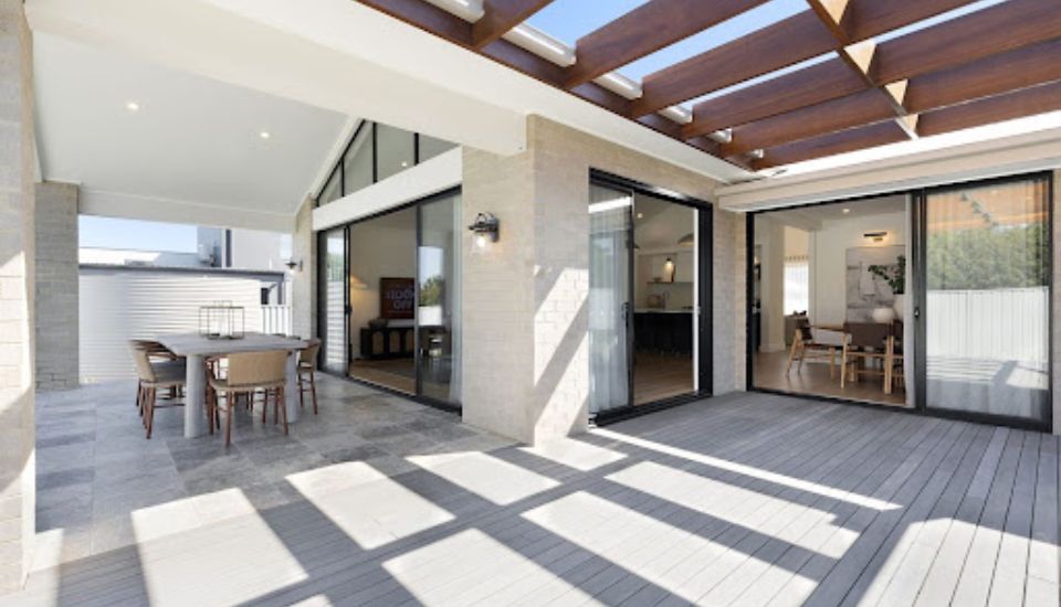 Comparison between an exposed alfresco area with open-air dining and an enclosed all-season outdoor room with weather protection and comfortable seating.